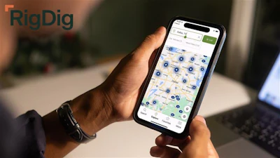 Person holding smartphone displaying RigDig map application with location markers and search interface